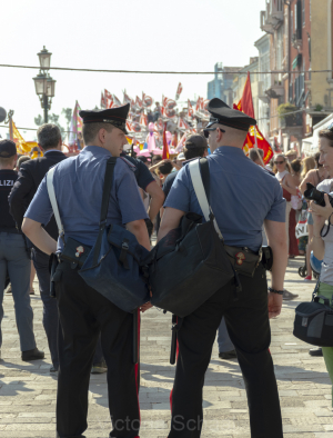 Two carabinieri in front of protesters against cruise ships in Venice