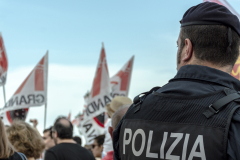 Policeman in front of protesters against cruise ships in Venice